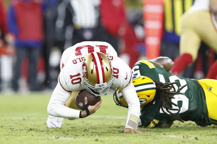Jan 22, 2022; Green Bay, Wisconsin, USA; San Francisco 49ers quarterback Jimmy Garoppolo (10) is sacked by Green Bay Packers outside linebacker Za'Darius Smith (55) in the first quarter during a NFC Divisional playoff football game at Lambeau Field. Mandatory Credit: Jeff Hanisch-USA TODAY Sports